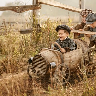 Children on wooden racing car