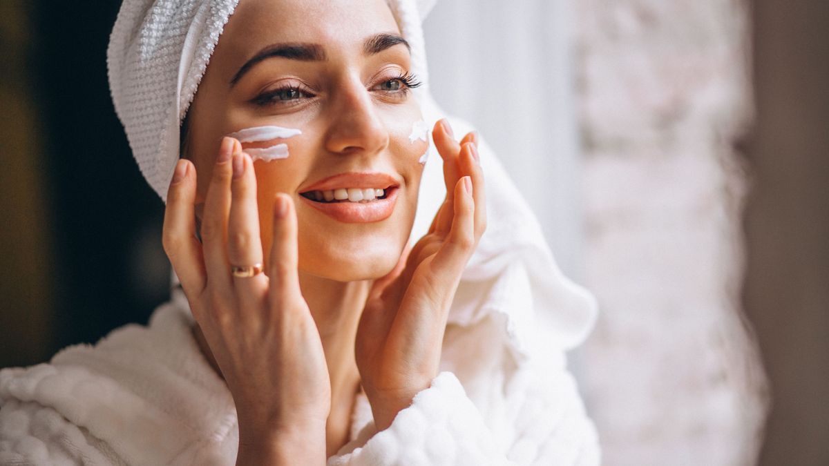 Woman applying face cream