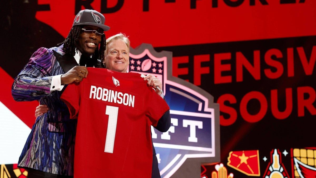 Syndication: The Tennessean Darius Robinson, a defensive lineman from the University of Missouri, stands with NFL commissioner Roger Goodell and shows off his Arizona Cardinals jersey after he was ...
