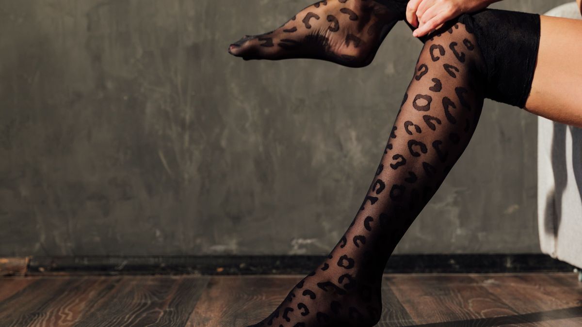 a woman wears black tights on slender beautiful legs
