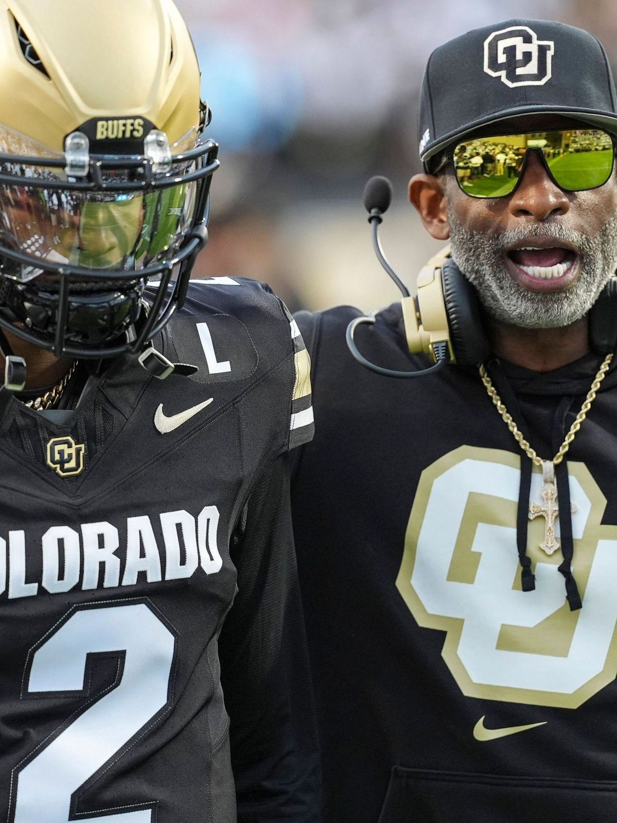 September 21, 2024: Colorado Buffaloes head coach Deion Sanders chats with his son Colorado Buffaloes quarterback Shedeur Sanders (2) before the football game between Colorado and Baylor in Boulder...