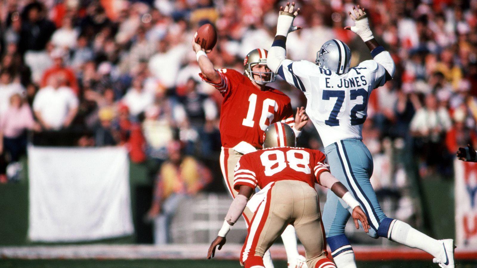 
                <strong>1980er: Die Joe-Montana-Ära - Auf Cowboys-Dominanz folgt Niners-Dominanz</strong><br>
                Was Roger Staubach für die Cowboys war, wurde Joe Montana für die 49ers. 1981 gab er sein Debüt in der Rivalität und sollte am Ende alle sechs Spiele gegen die Cowboys gewinnen. In den 80ern wurde nicht nur die NFC, sondern die ganze NFL von Montana und den 49ers dominiert. Unter den Head Coaches Bill Walsh und George Seifert gewinnt die Franchise aus Kalifornien vier Super Bowls (XVI, XIX, XXIII, XXIV). Retrospektiv ist der berühmteste dieser Siege der erste ...
              