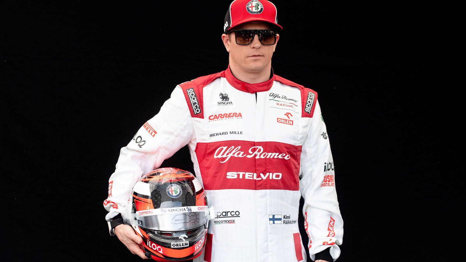 
                <strong>Kimi Räikkönen (Alfa Romeo Racing)</strong><br>
                Der Helm von Kimi "The Iceman" Räikkönen ähnelt dem Helm der vergangenen Saison sehr. Eine Mischung aus Weiß und Orange dominiert auf dem Kopfschutz des Finnen.
              