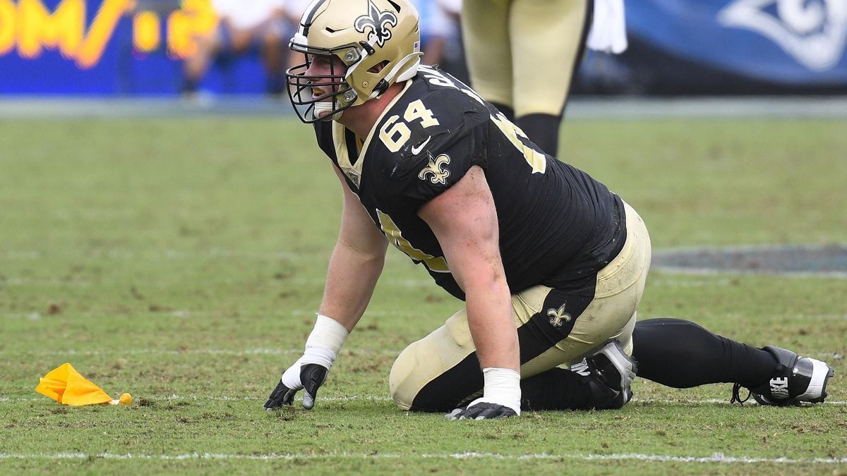 LOS ANGELES, CA - SEPTEMBER 15: New Orleans Saints Center Will Clapp (64) lays on the field as a flag is thrown in his direction for holding during an NFL, American Football Herren, USA game betwee...