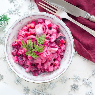 Salad with beets and herring in festive Christmas decorations, horizontal