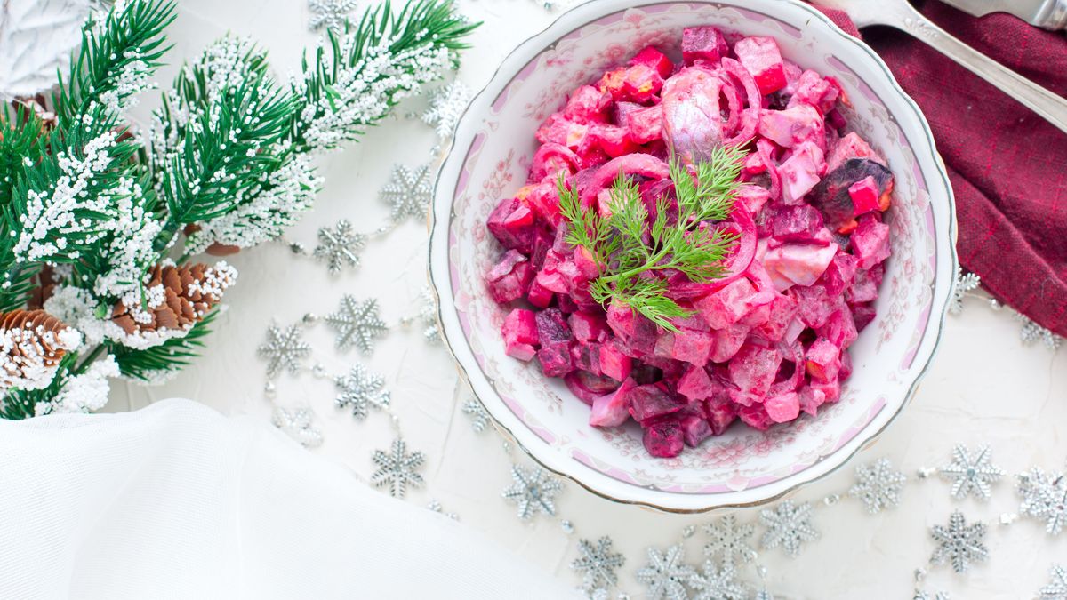 Salad with beets and herring in festive Christmas decorations, horizontal