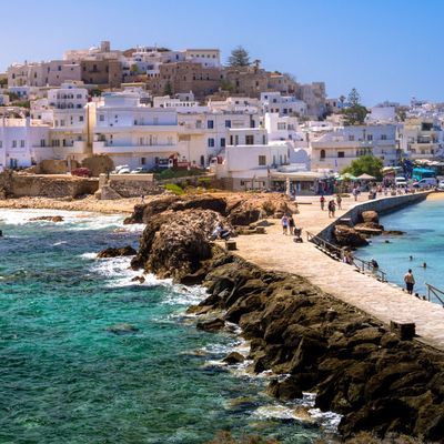 Chora of Naxos island as seen from the famous landmark the Portara with the natural stone walkway towards the village, Cyclades, Greece.