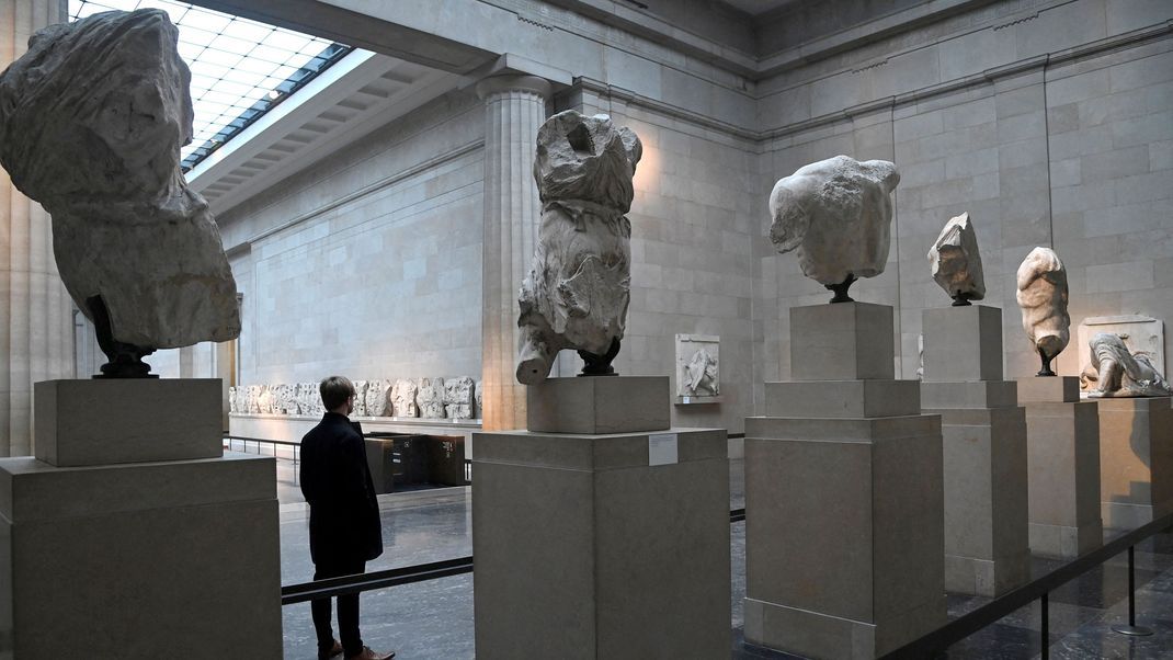 FILE PHOTO: An employee views examples of the Parthenon sculptures, sometimes referred to in the UK as the Elgin Marbles, on display at the British Museum in London, Britain, January 25, 2023. REUTERS/Toby Melville/File Photo