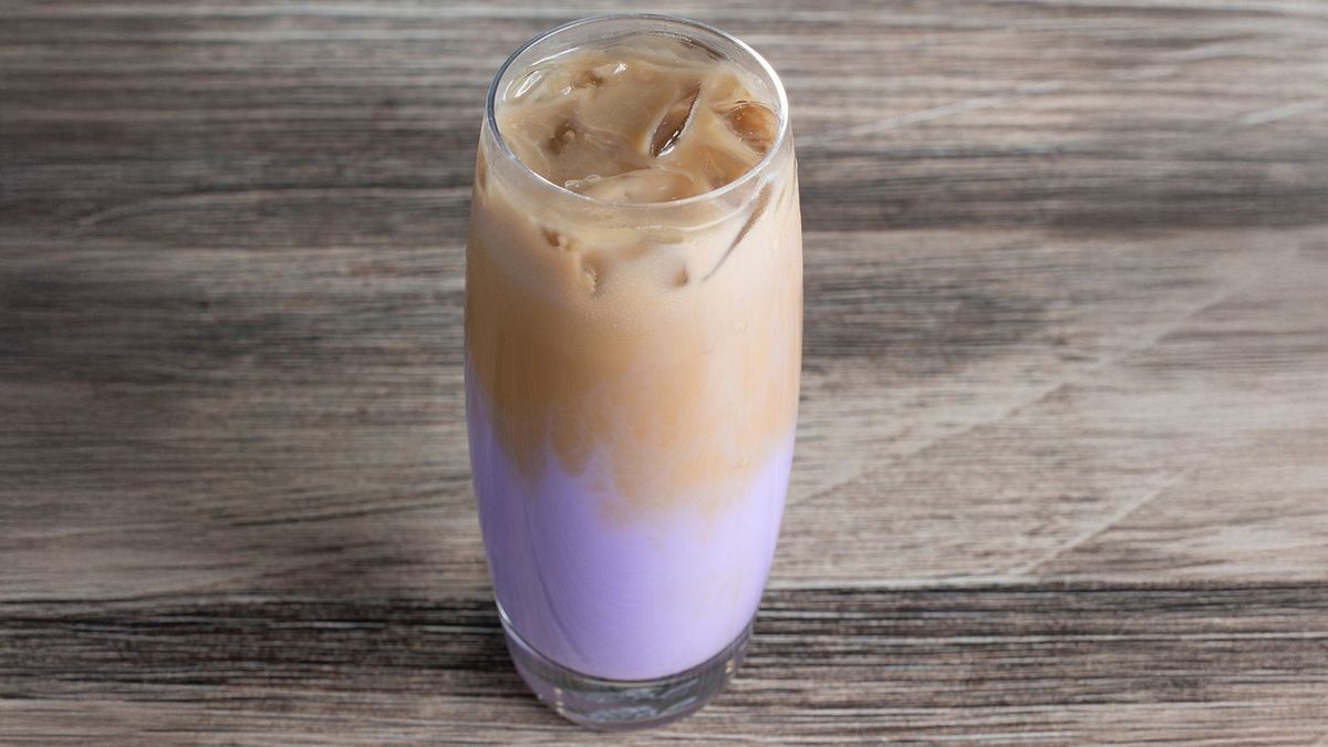A view of a cold taro latte beverage.