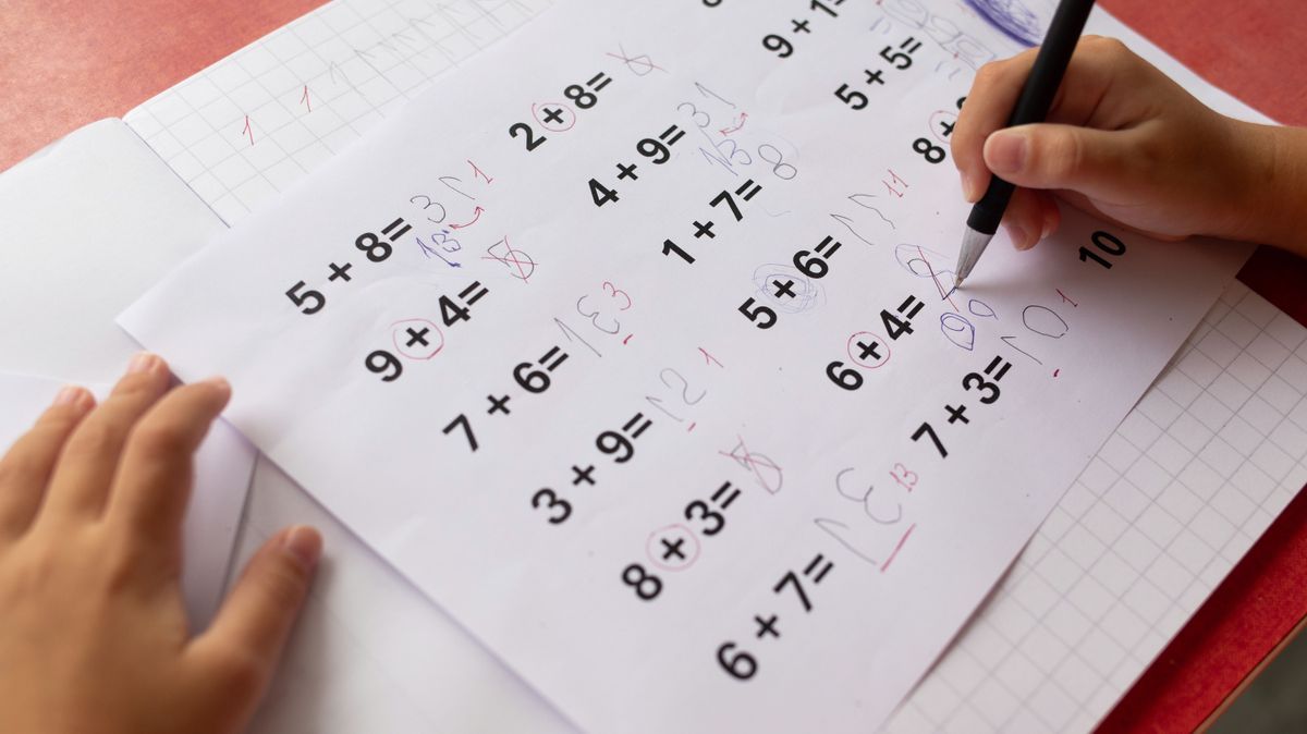 A childs math homework, affected by dyslexia and dyscalculia, is covered in corrections.