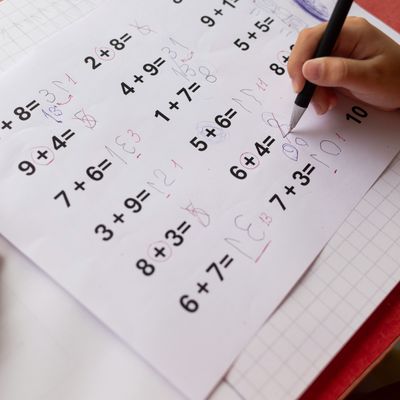 A childs math homework, affected by dyslexia and dyscalculia, is covered in corrections.