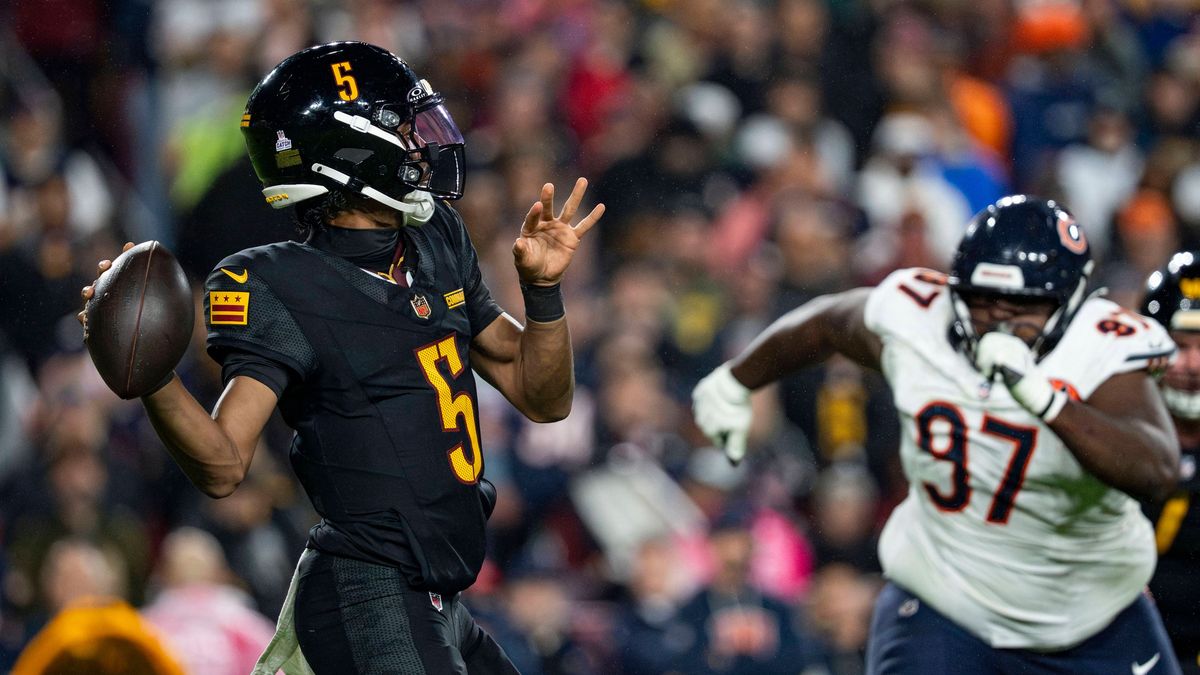 Washington Commanders quarterback Jayden Daniels (5) as Chicago Bears defensive tackle Eddie Goldman (97) advances during a game at Northwest Stadium in Landover, Maryland on Monday, October 13, 20...