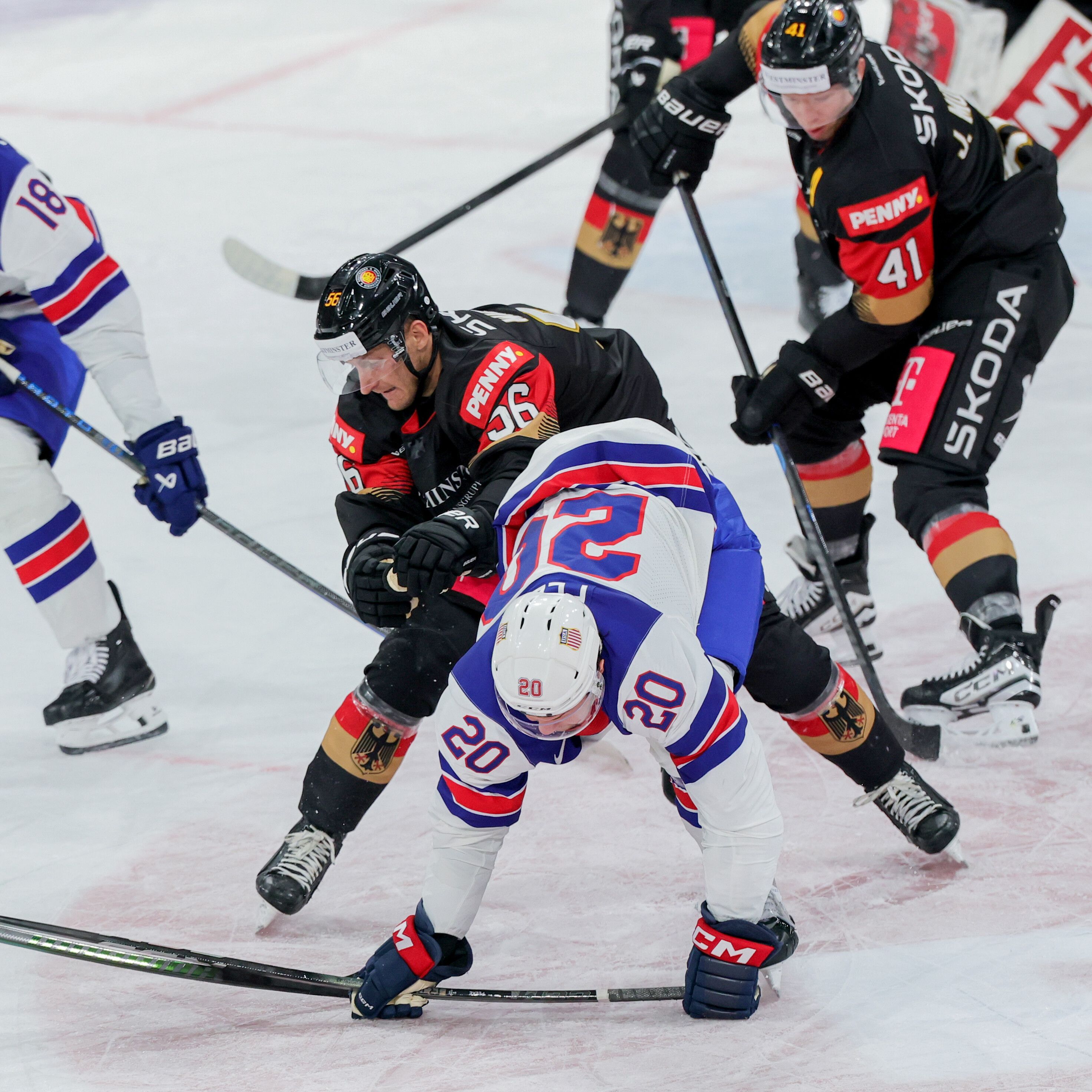 Eishockey: Länderspiel, Deutschland - USA, PSD Bank Dome, Deutschands Manuel Wiederer (56)) und Andrew Peeke aus den USA versuchen an den Puck zu kommen.