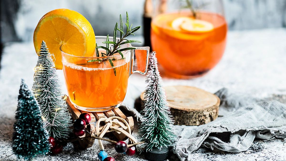 Cups of aperitif with Christmas decoration on table