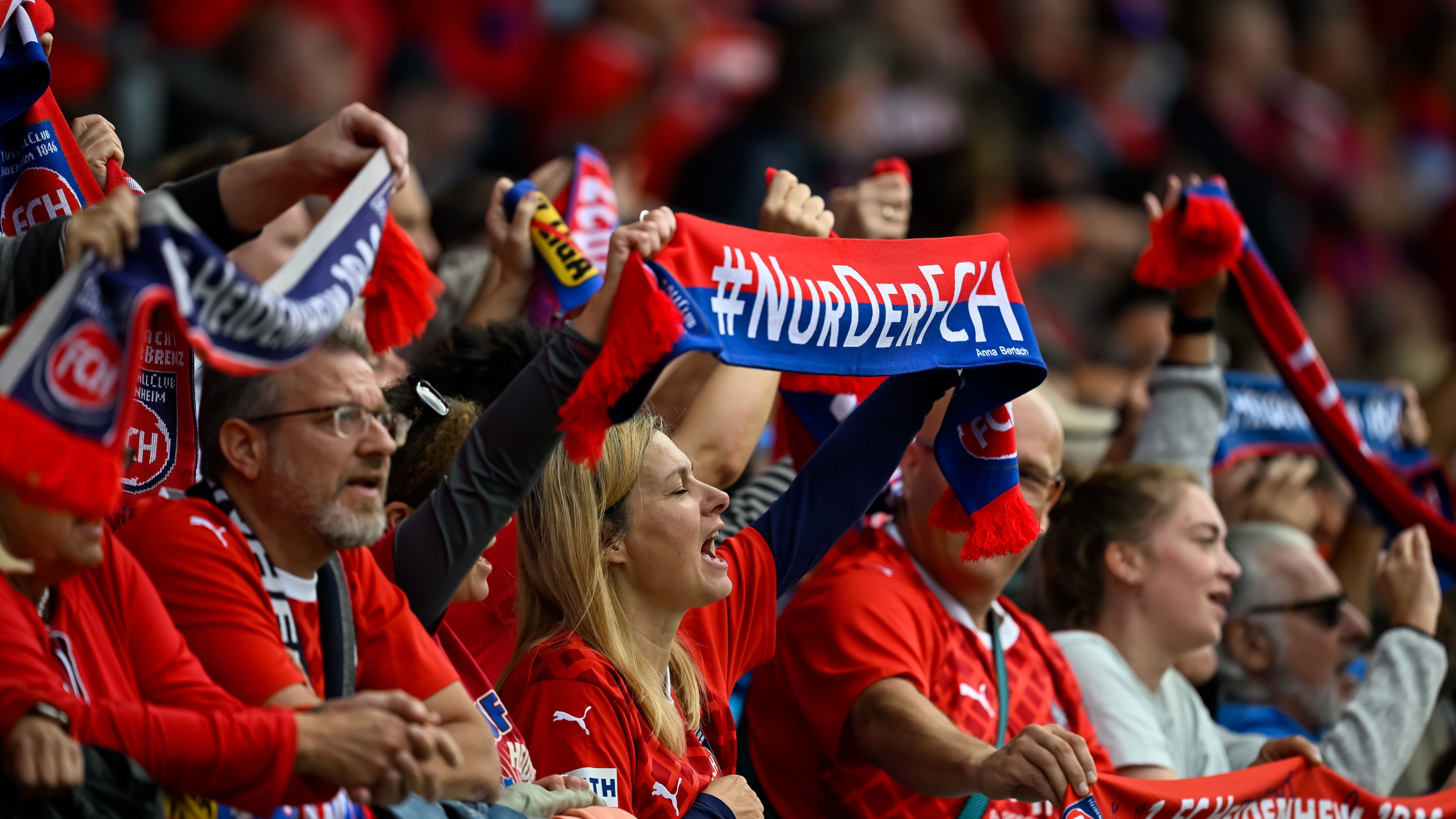 <strong>1. FC Heidenheim</strong><br>"In Heidenheim, so grün und rot, der 1. FC Heidenheim, unser Verein, der uns ins Herz so lockt. Gegründet 1846, im Schatten des Schlosses so klug, die Schlossstädter stark, auf dem Platz, das ist unser Glück. Mit dem Herzen dabei, ...