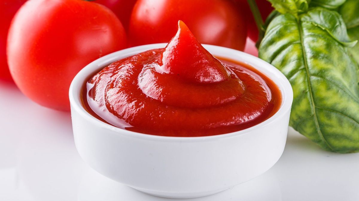 fresh natural tomato ketchup on a white background