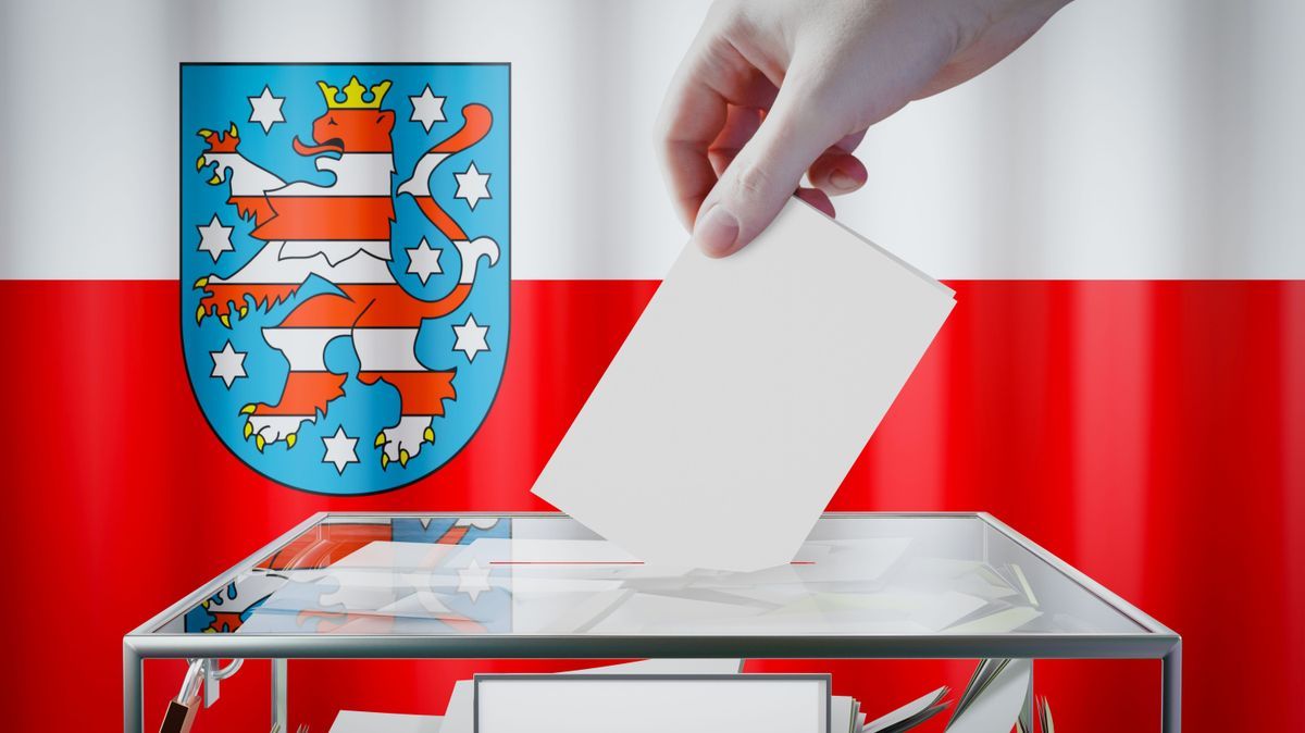 Thuringia flag, hand dropping ballot card into a box - voting/ election in Germany concept - 3D illustration