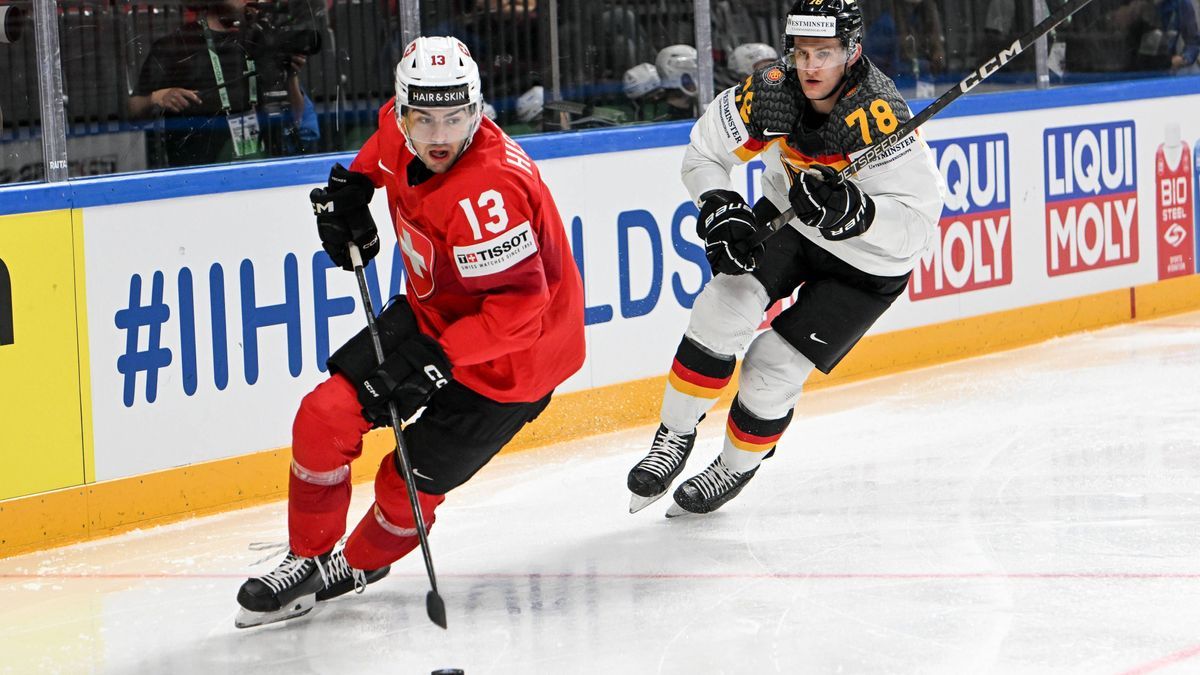RIGA, LATVIA - MAY 25: Nico Hischier of Switzerland defends the puck against Nico Sturm of Germany during the 2023 IIHF Ice hockey, Eishockey World Championship, WM, Weltmeisterschaft Finland - Lat...