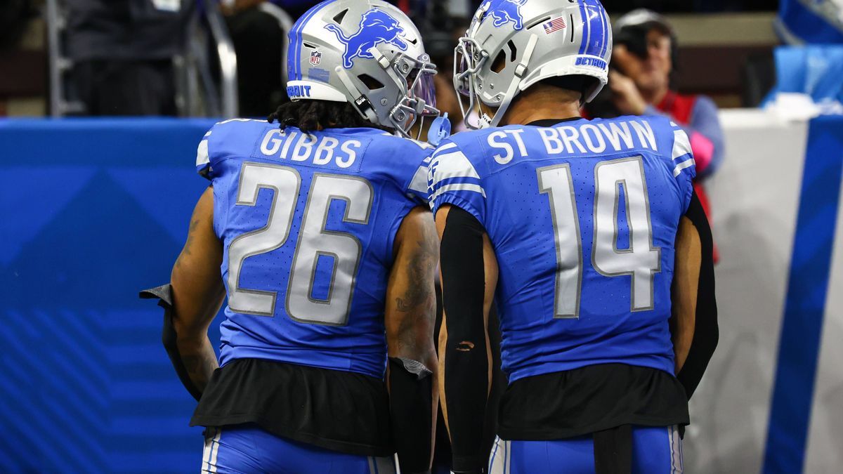 DETROIT, MI - JANUARY 21: Detroit Lions running back Jahmyr Gibbs (26) and Detroit Lions wide receiver Amon-Ra St. Brown (14) celebrate after Gibbs scored a touchdown on a running play during an NF...