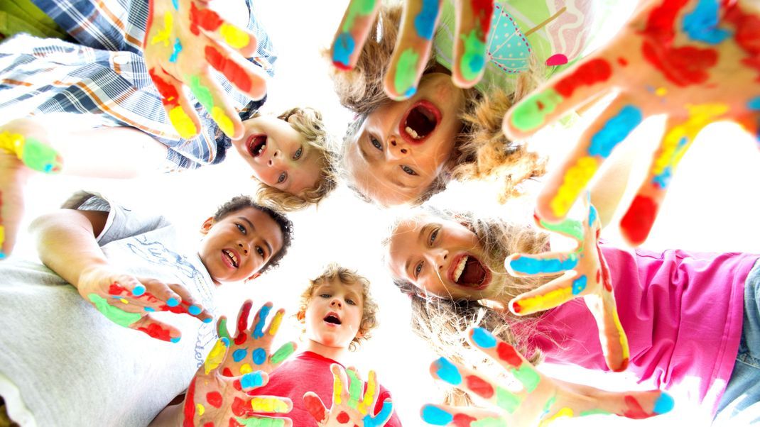 smiling kids with colourfull hands
