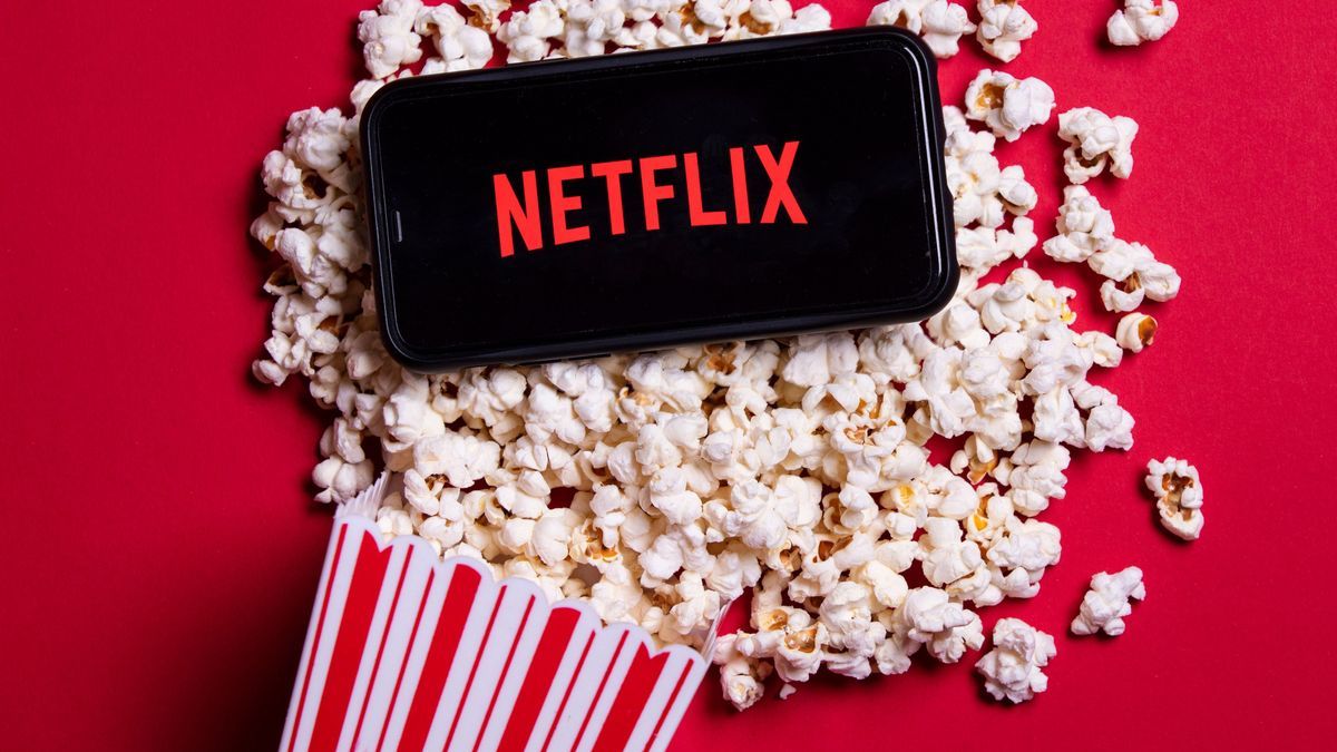 LONDON, UK - MAY 14 2020: Netflix logo on a smartphone with popcorn