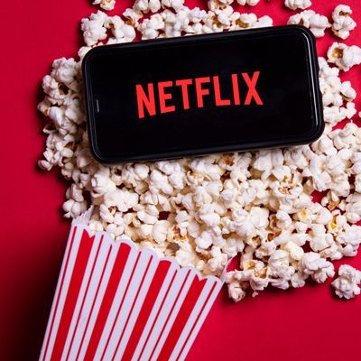 LONDON, UK - MAY 14 2020: Netflix logo on a smartphone with popcorn