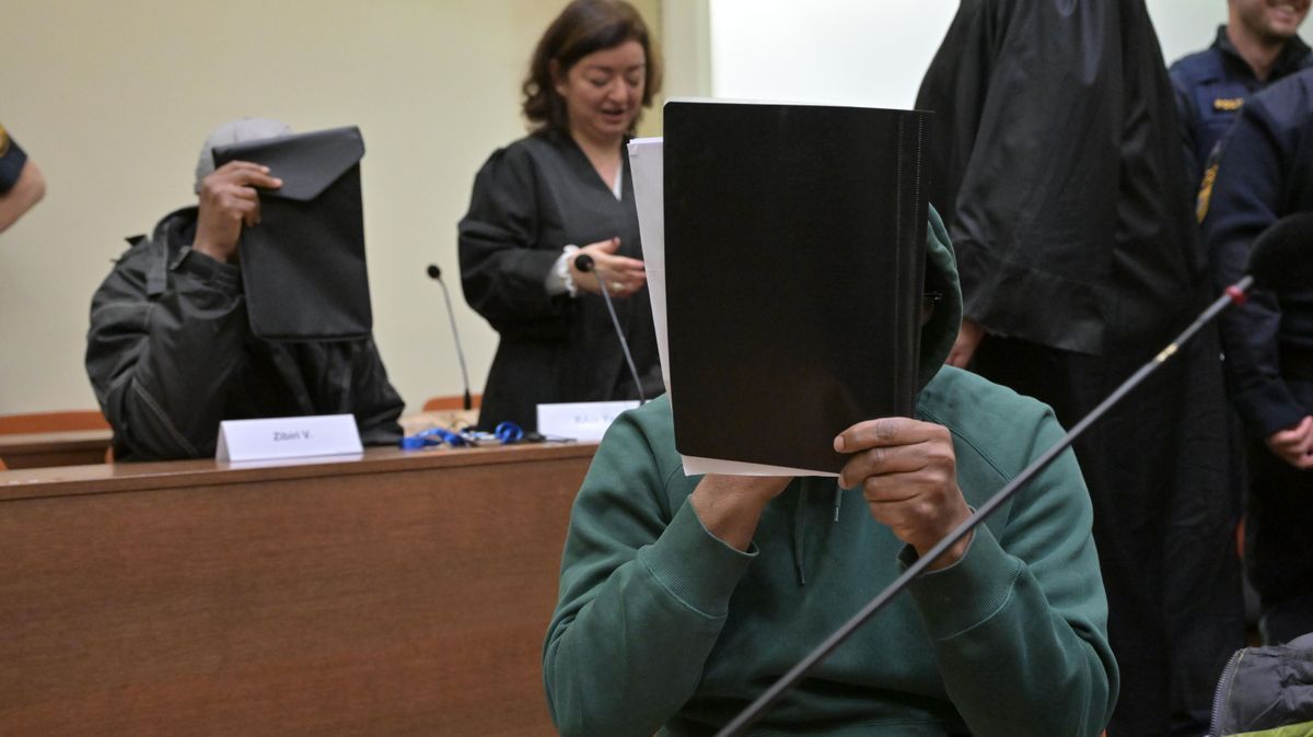 Mutmaßliche Mitglieder der nigerianischen Mafia sitzen zu Prozessauftakt im Gerichtssaal.