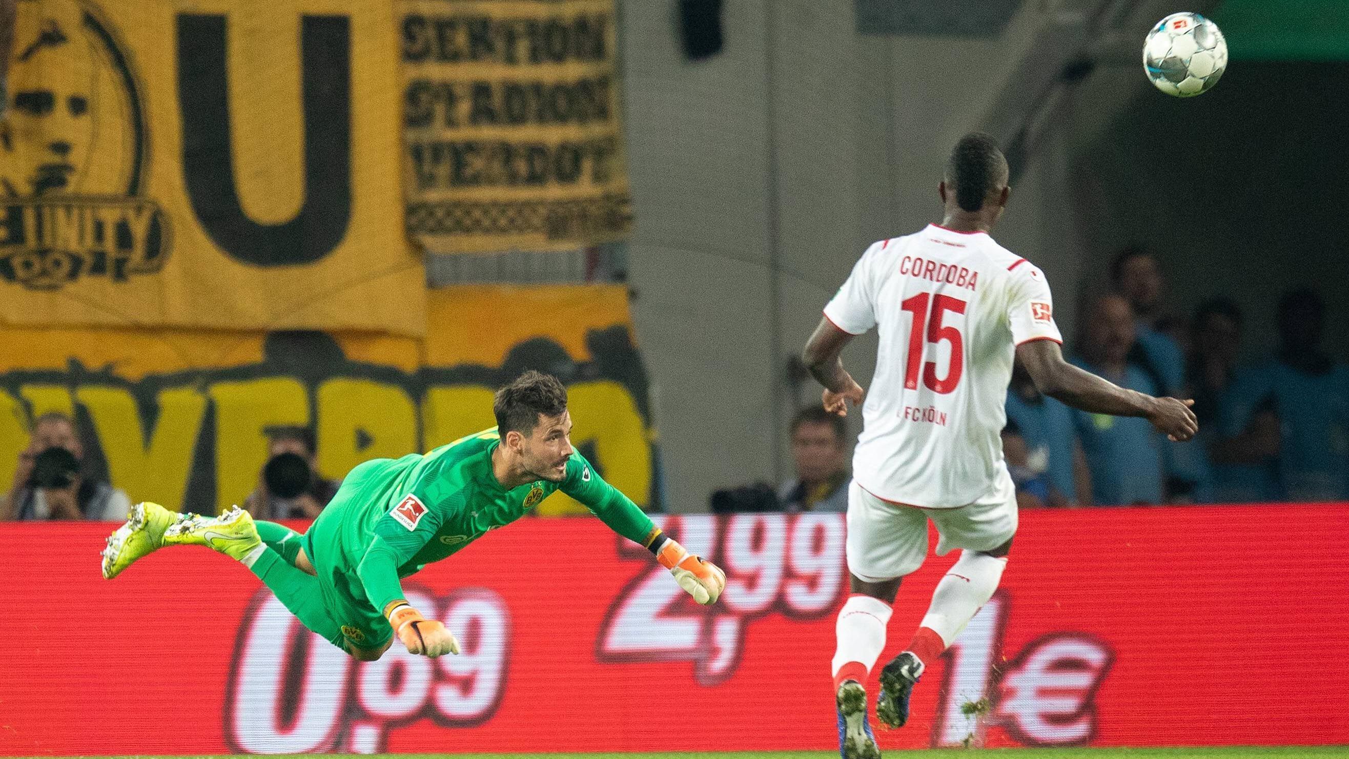 
                <strong>Roman Bürki</strong><br>
                Hat beim 1:0 der Kölner aus kurzer Distanz keine Chance. Verschuldet nach knapp einer halben Stunde eine Ecke, nachdem er ins Luftloch tritt - und kann es selbst kaum glauben. Kurz vor der Pause sorgt er für eine Schrecksekunde beim BVB, als er sich im Dribbling verzettelt und beim Kölner Pressing den Ball vor dem Tor gegen Cordoba verliert. Danach weniger gefordert. ran-Note: 5
              