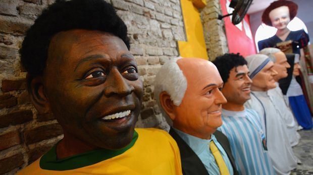 
                <strong>Karnevalsmasken</strong><br>
                Brasilien liebt seine Fußball-Stars und so treten Pelé, FIFA-Präsident Joseph Blatter und Diego Maradona (v. l.) schon mal gemeinsam beim Karneval auf - als Masken. 
              