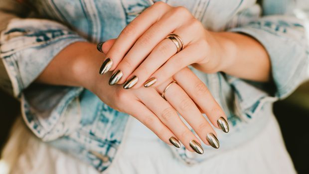 Stylish trendy female mirror manicure, metal nail art