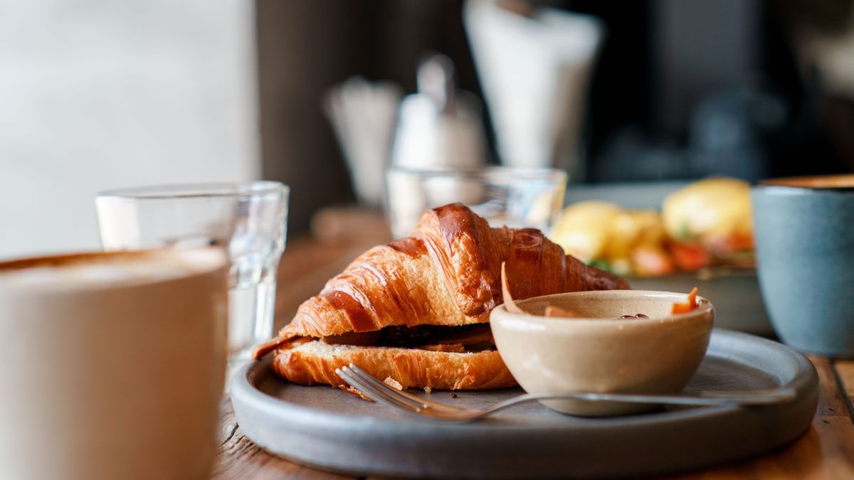 breakfast with eggs and coffee and croissant