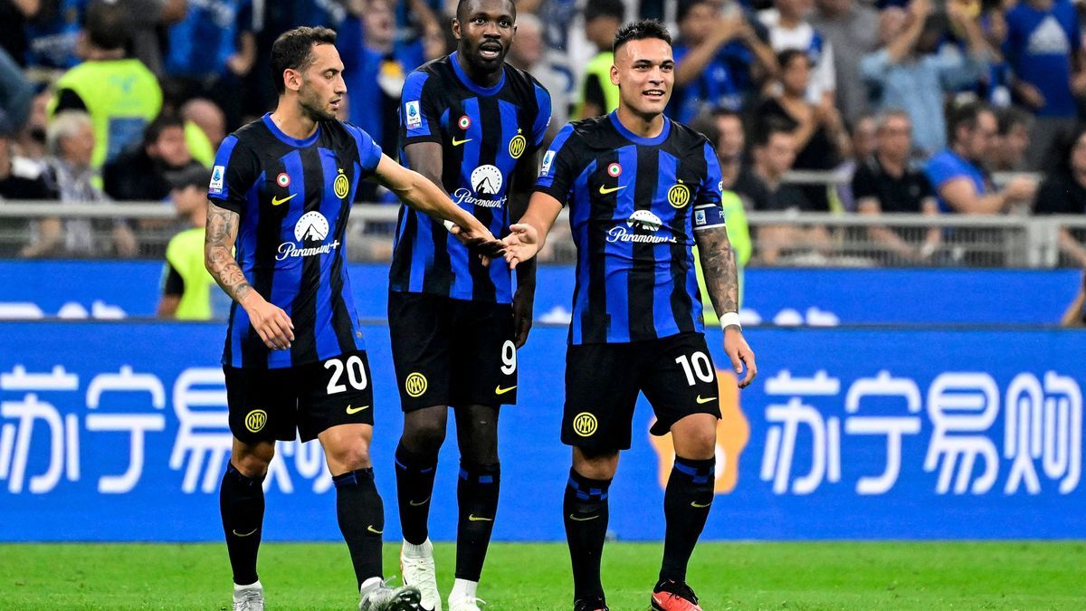 Marcus Thuram of FC Internazionale celebrates with Lautaro Martinez (r) and Hakan Calhanoglu (l) after scoring the goal of 2-0 during the Serie A football match between FC Internazionale and AC Mil...