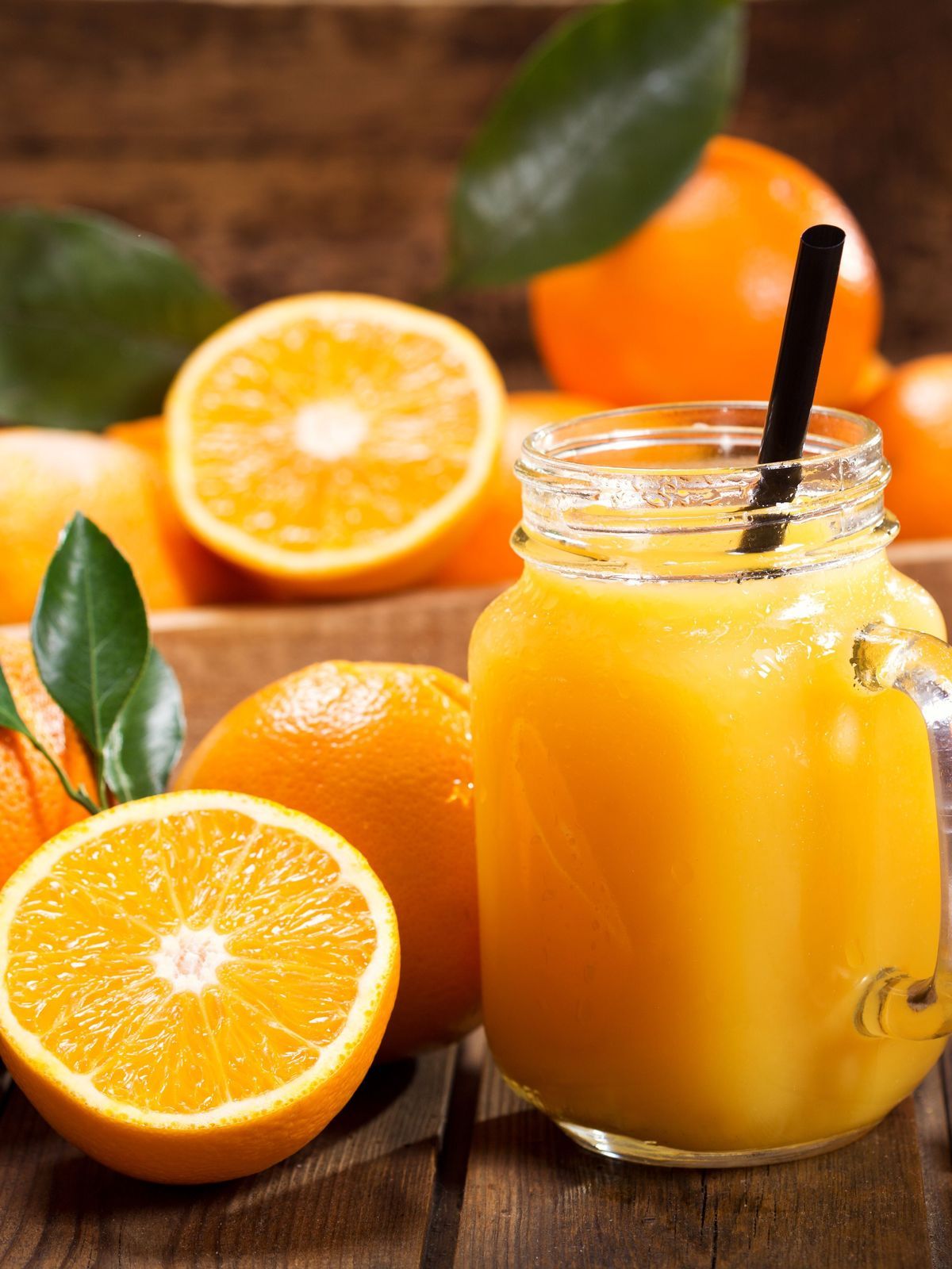 glass jar of fresh orange juice with fresh fruits