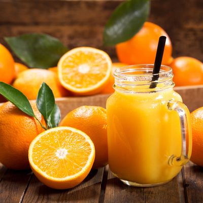 glass jar of fresh orange juice with fresh fruits