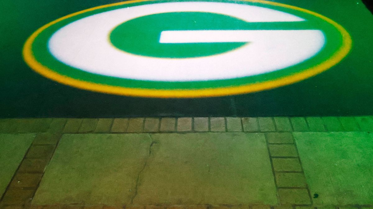 GREEN BAY, WI - AUGUST 24: The Green Bay Packer logo lights up the tunnel in front of their historic championship bricks during a game between the Green Bay Packers and Baltimore Ravens on August 2...