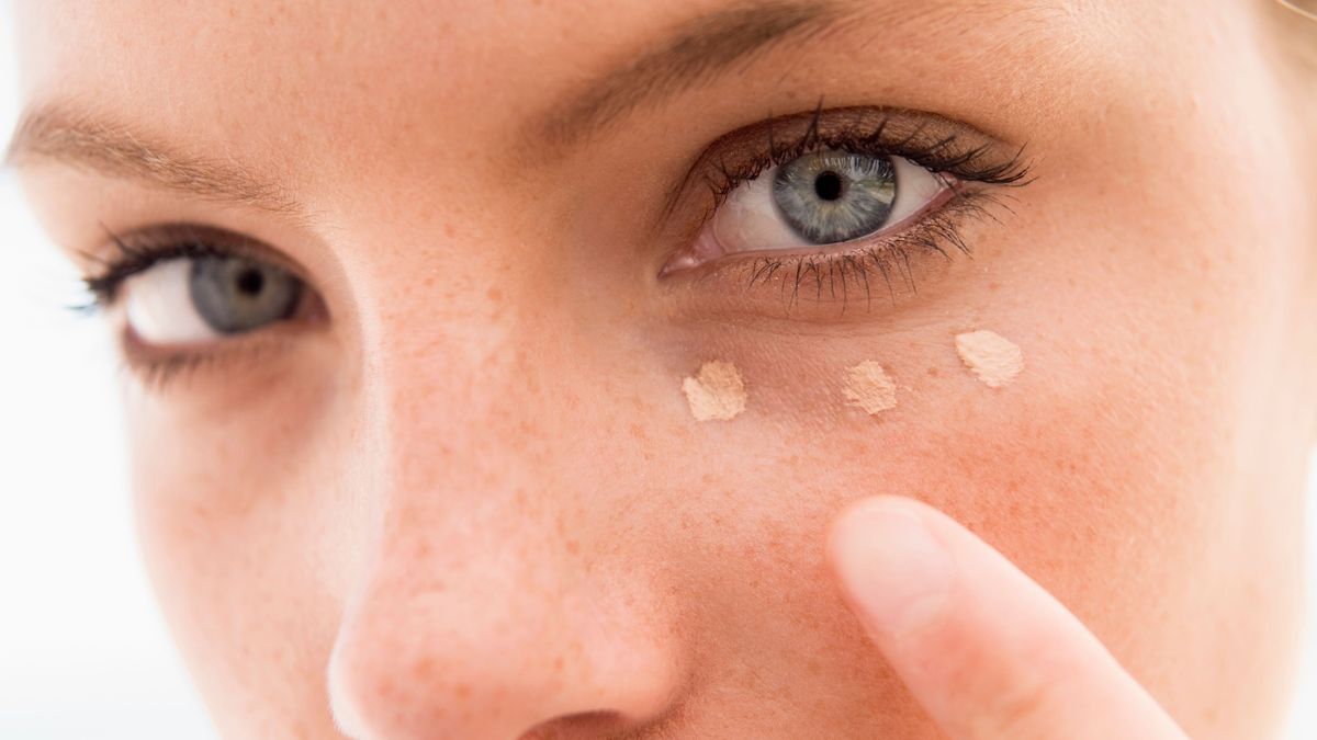 Close up of woman putting on make up