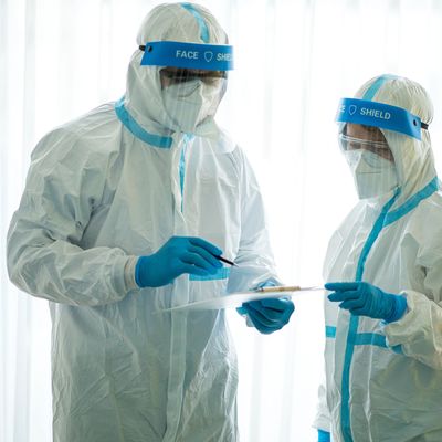 Asian doctor holding checking coronavirus or covid-19 infected patient name list sheet in quarantine area in hospital. Corona virus, Covid 19 virus outbreak, medical mask or virus outbreak concept
