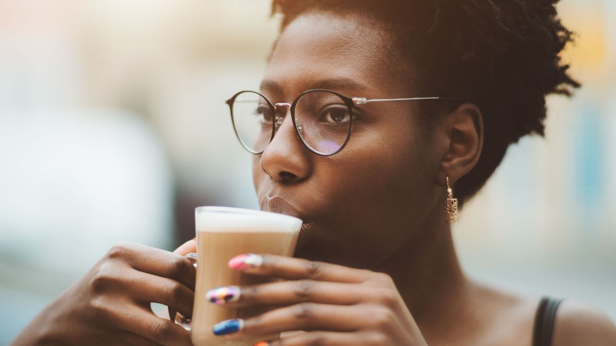 Black girl with nail art and coffee