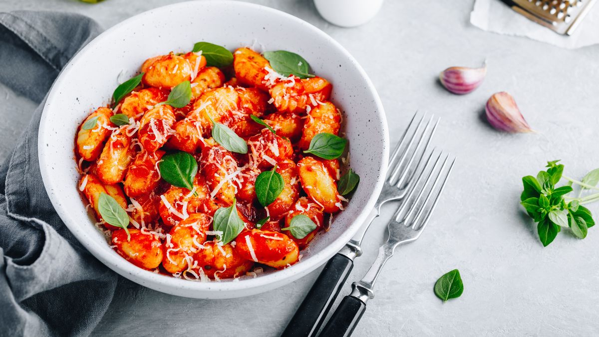 Traditional Italian potato Gnocchi with tomato sauce, parmesan cheese and fresh basil