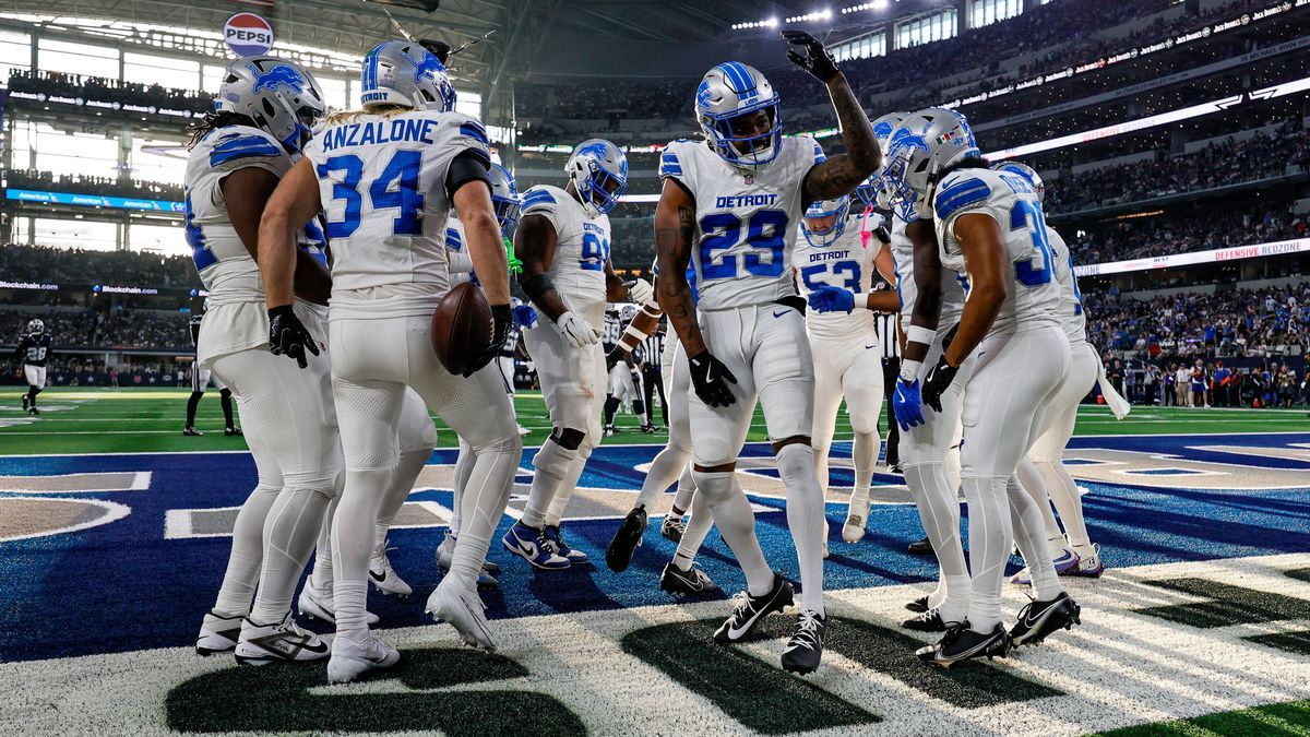 ARLINGTON, TX - OCTOBER 13: Detroit Lions safety Brian Branch (32) celebrates an interception with his teammates during the game between the Dallas Cowboys and the Detroit Lions on October 13, 2024...