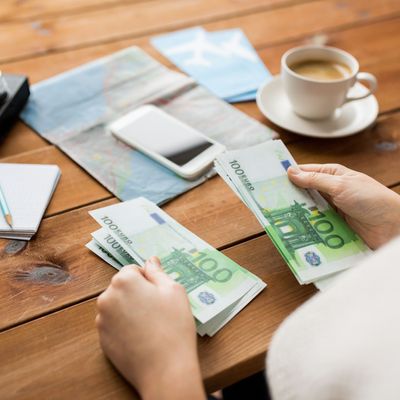 close up of traveler hands counting euro money