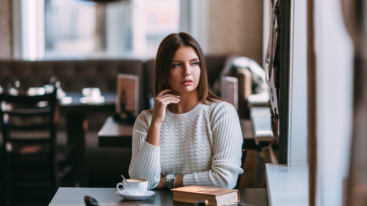 woman sitting in the cafe with a cup of coffee