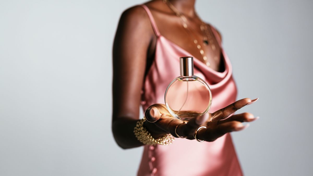 Anonymous African American woman showing perfume