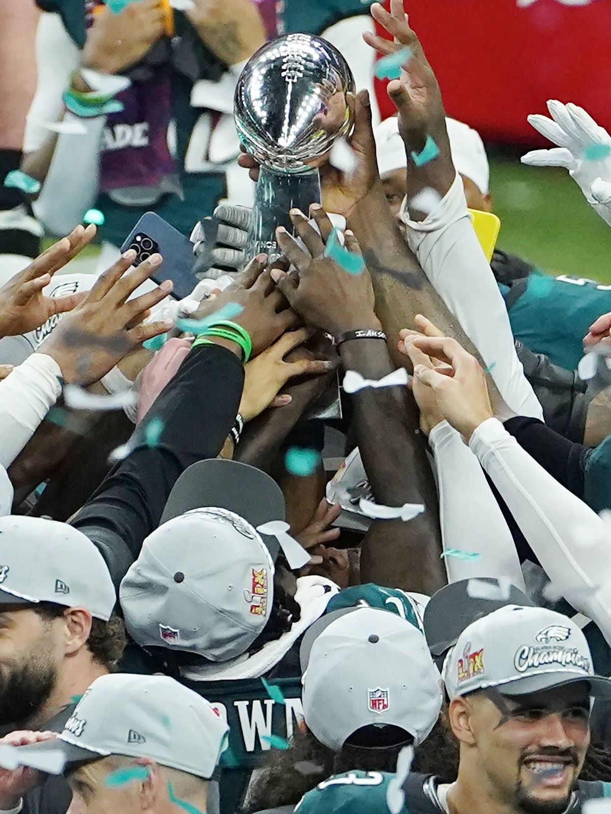 Philadelphia Eagles players hold the Vince Lombardy Trophy after defeating the Kansas City Chiefs 40-22 in Super Bowl LIX at Caesars Superdome in New Orleans on Sunday, February 9, 2025. PUBLICATIO...