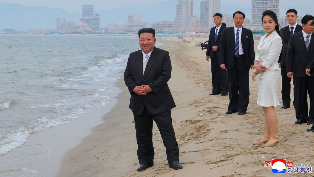 26. Juni 2025, Nordkorea, Wonsan: Die Aufnahme der staatlichen nordkoreanischen Nachrichtenagentur KCNA zeigt den nordkoreanischen Machthaber Kim Jong-un (Mitte) zusammen mit seiner Tochter Kim Ju Ae am Strand von Wonsan bei der Eröffnung des Touristengebiets Wonsan-Kalma.