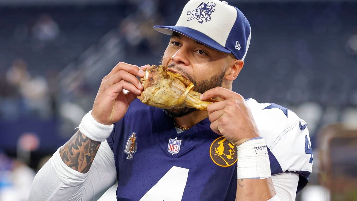 ARLINGTON, TX - NOVEMBER 23: Dallas Cowboys quarterback Dak Prescott (4) celebrates eating a turkey leg after the game between the Dallas Cowboys and the Washington Commanders on November 23, 2023 ...