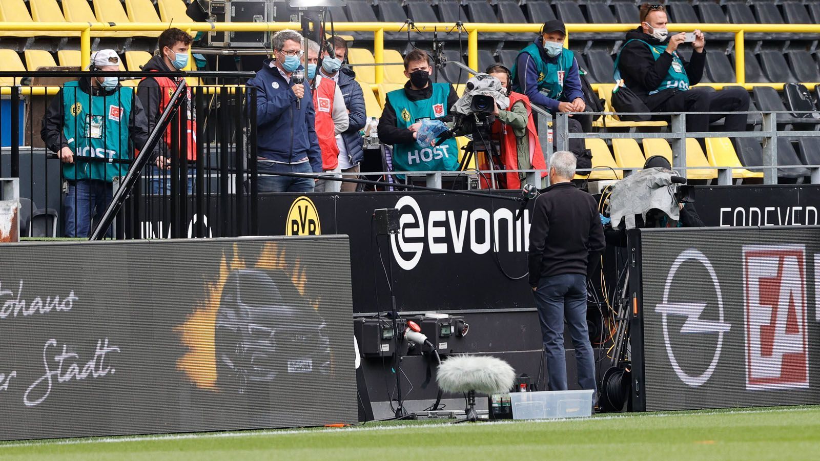 
                <strong>Die kuriosen Bilder des Bundesliga-Restarts</strong><br>
                Auch TV-Interviews werden in Zeiten von Corona zum Distanzgespräch, wie hier mit Lucien Favre. 
              