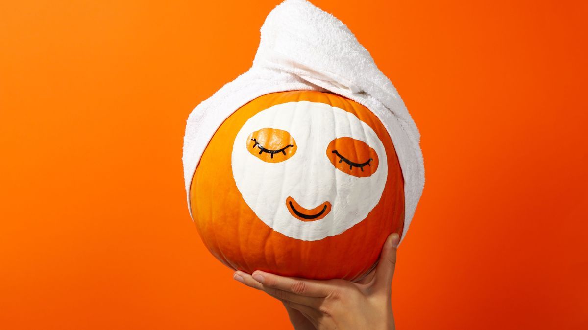 Skin and face care concept - pumpkin beauty mask