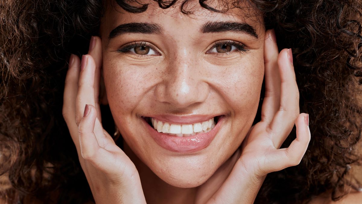 Skincare, beauty and face portrait of woman in studio isolated on a brown background. Makeup cosmetics, aesthetics and happy female model from Brazil feeling satisfied with healthy skin and wellness