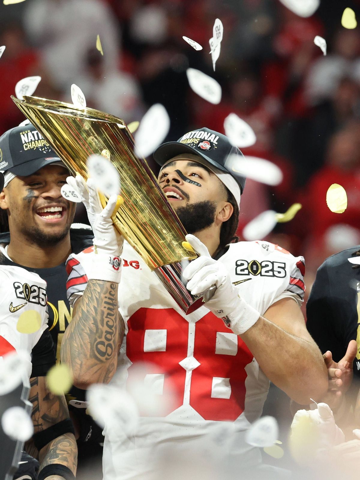 Ohio State tight end Gee Scott Jr. (88) holds the trophy after the Buckeyes defeated Notre Dame 34-23 to win the 2025 College Football Playoff National Championship at Mercedes-Benz Stadium in Atla...